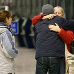 Family members comfort each other at Buffalo's airport